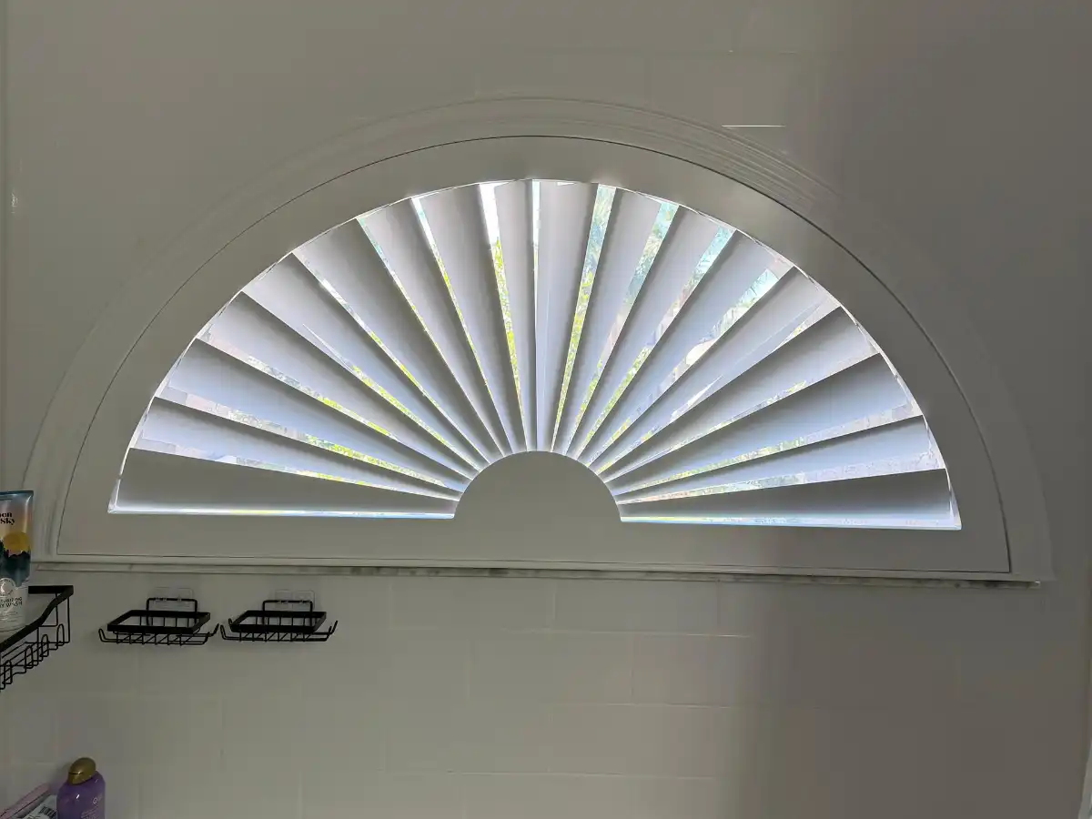 Plantation shutters on arched windows in a Coral Springs home